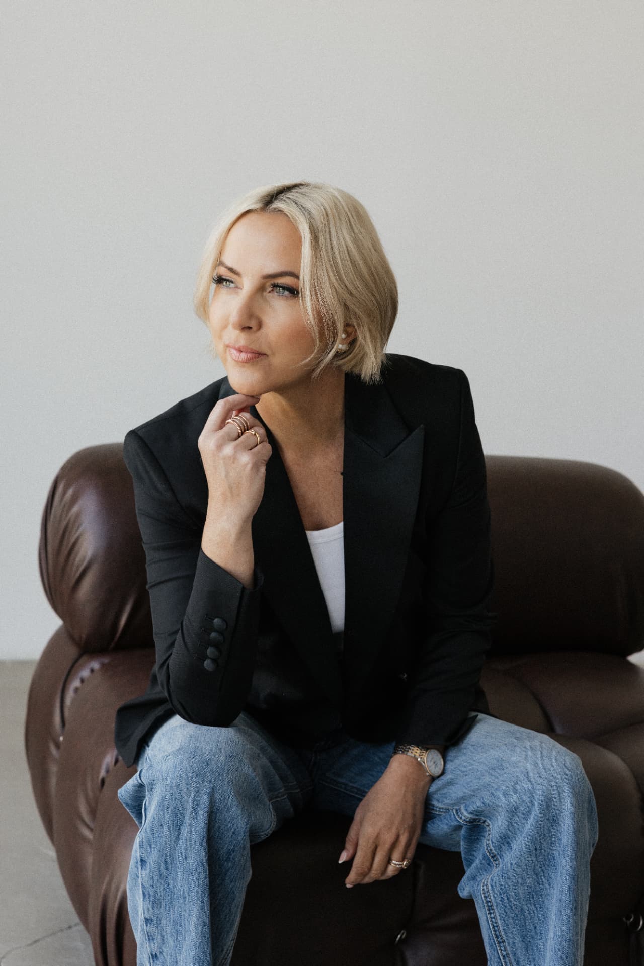 Kelly Lundberg seated, in thought