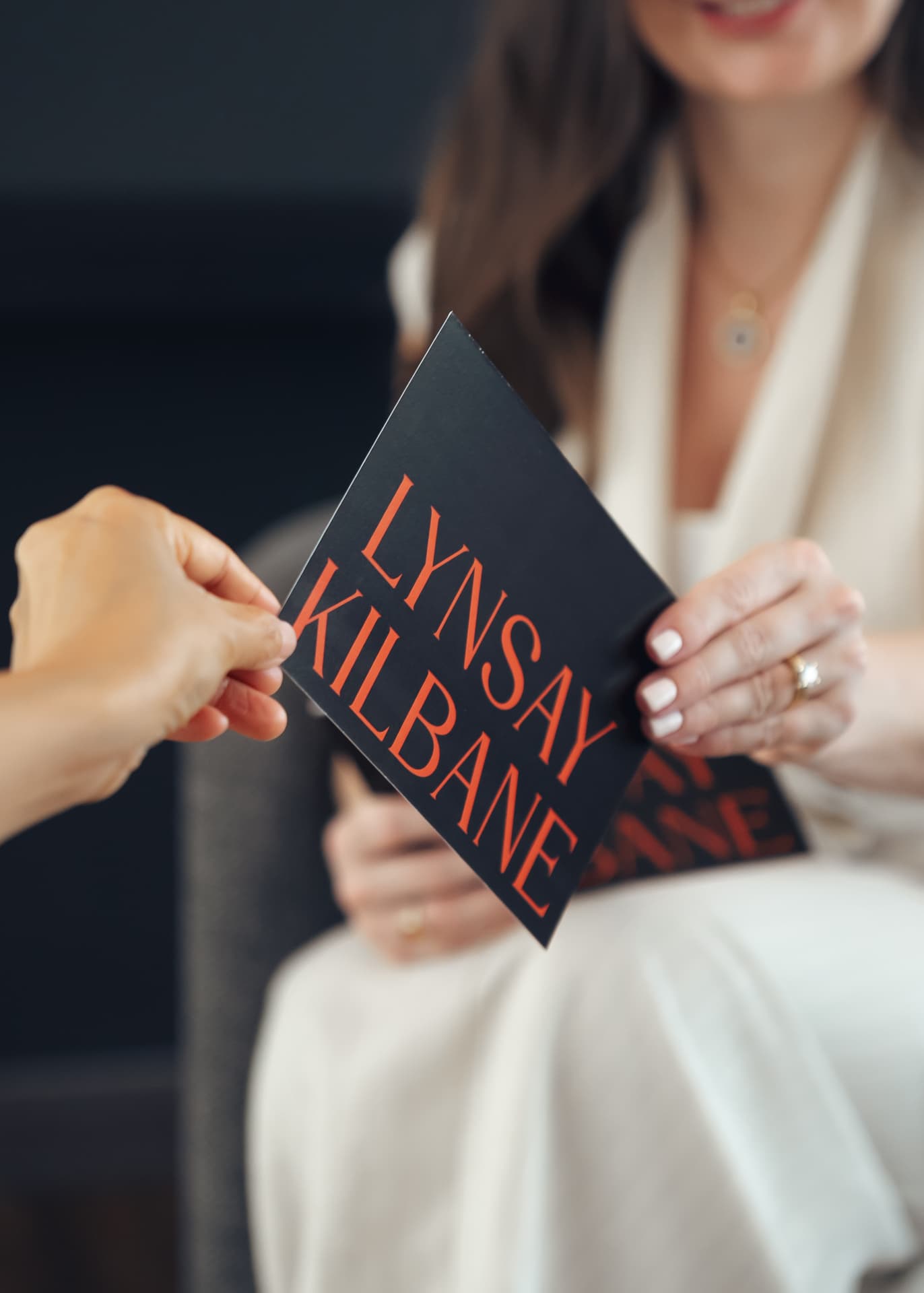A client receiving her personal brand identity collateral
